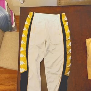 KAPPA black/gold track pants.Some discoloration neer the slits of the pockets